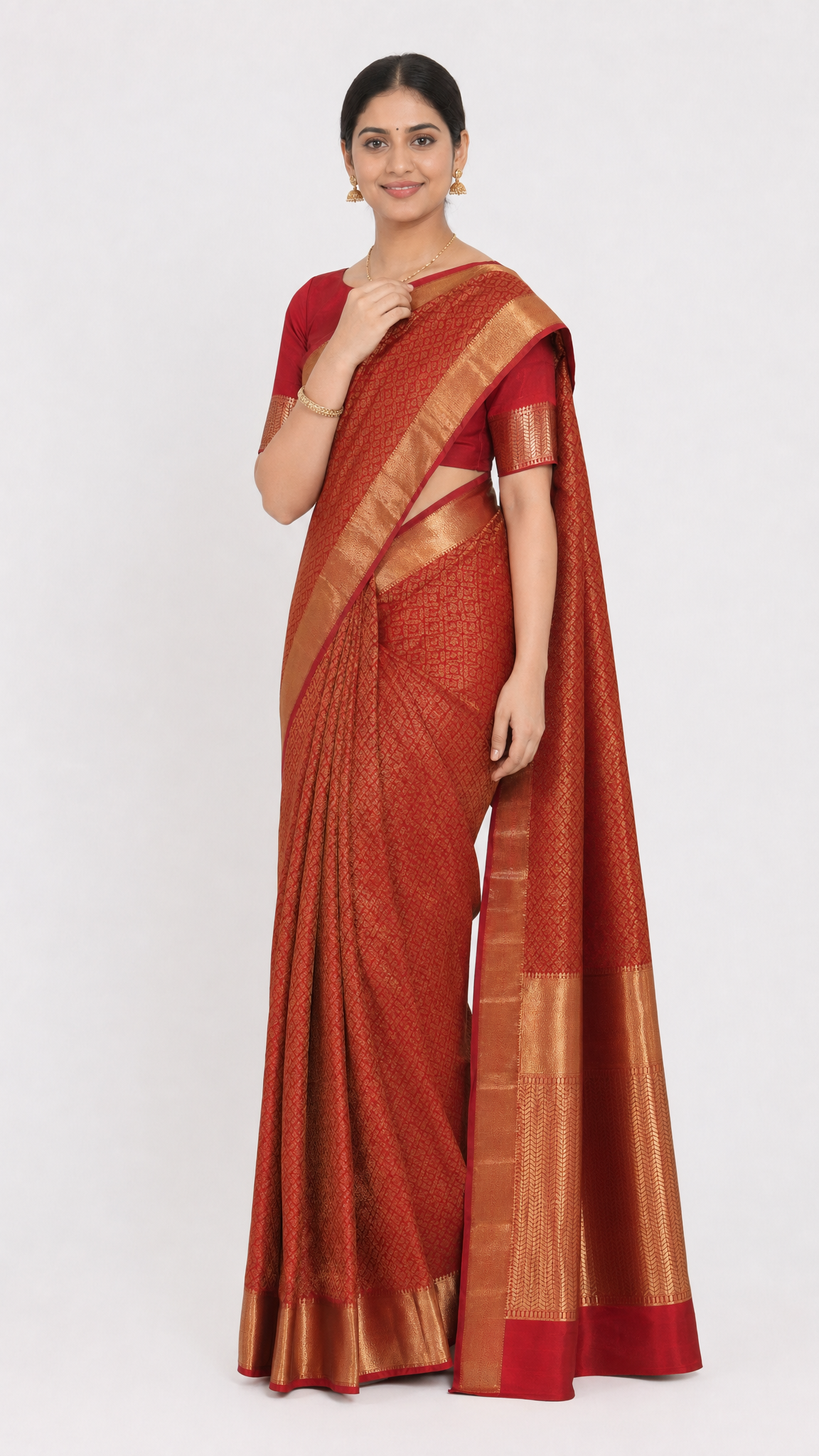 Red silk saree with gold border and draped pallu; short sleeve matching blouse
