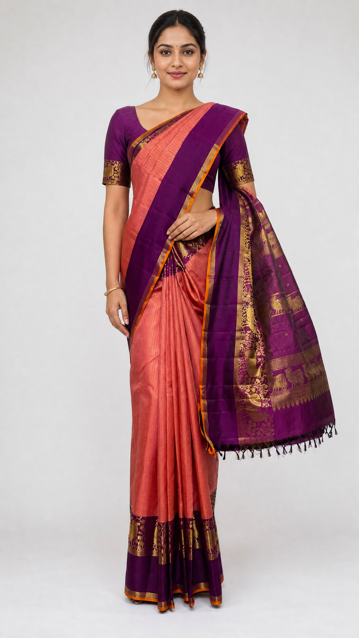 model wearing pure peach kanjivaram body kattam saree with magenta border and matching magenta blouse with zari work
