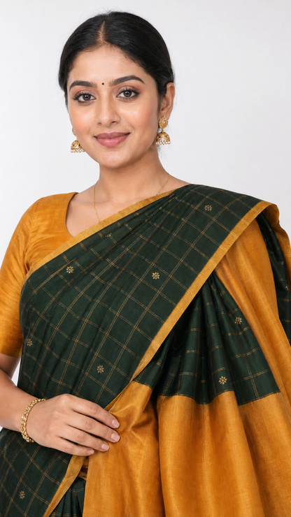 Kanjeevaram silk saree close-up: dark green checked pallu with gold trim on mustard