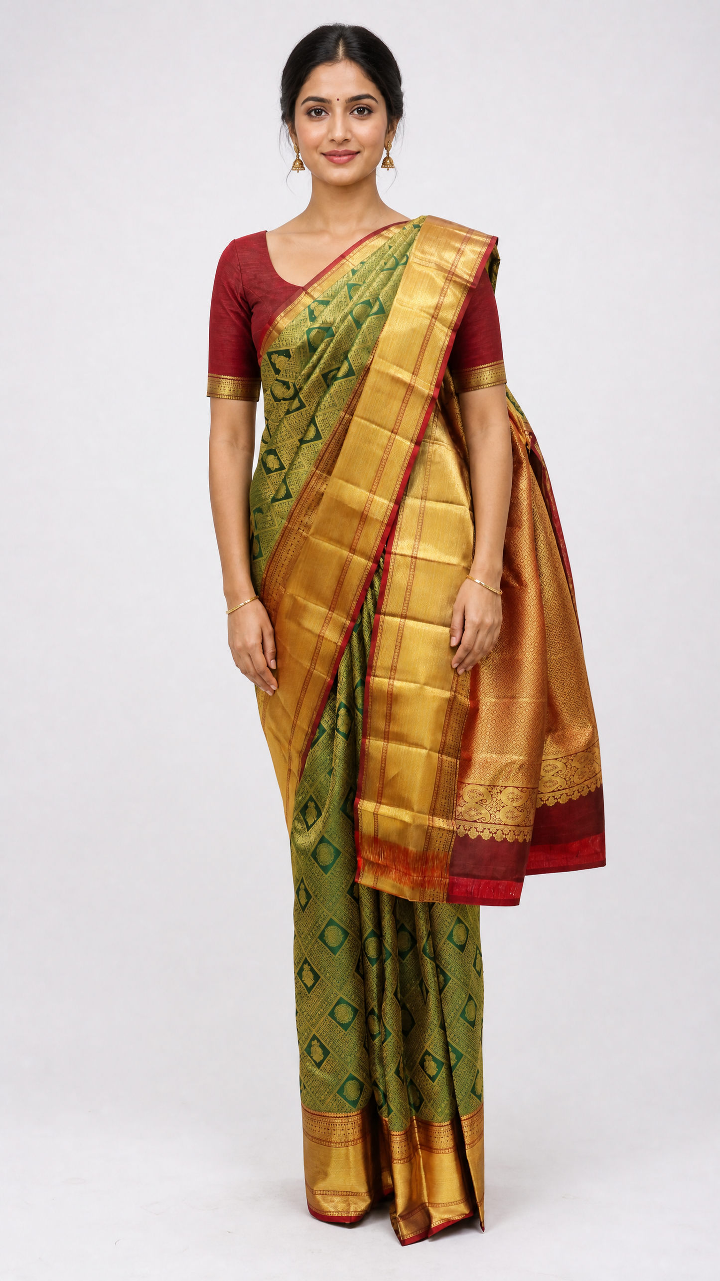 woman wearing kanjeevaram bottle green saree with maroon brocade and gold border