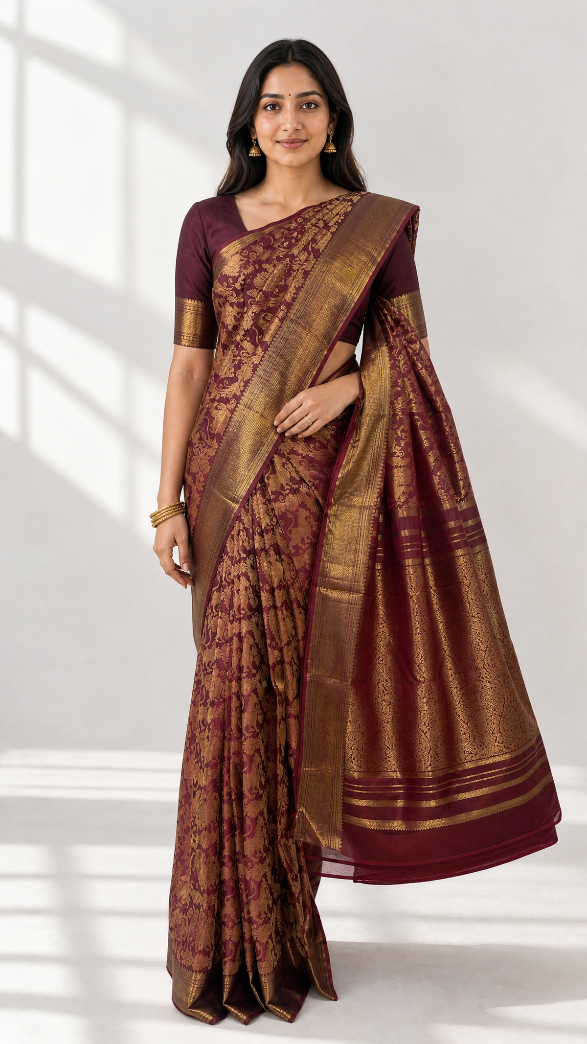 woman wearing kanjivaram brown jacquard saree with peacock motif and matching blouse with gold zari borders